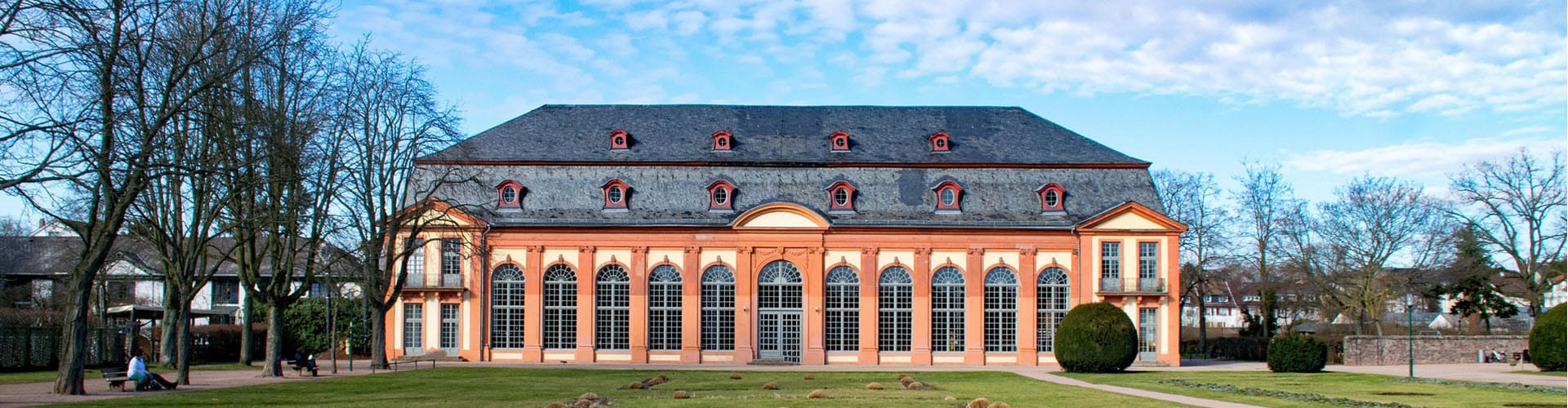 Peach-colored castle in Darmstadt located in a park.