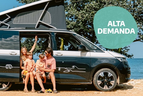 Family sitting in campervn ready for summer holidays