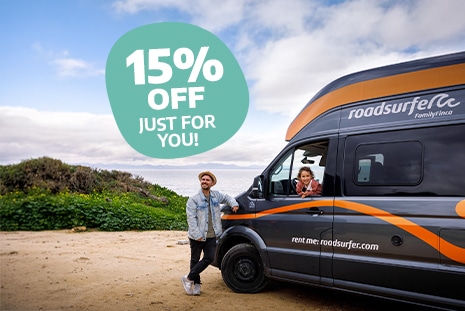 Early Bird Couple with campervan enjoying their roadtrip