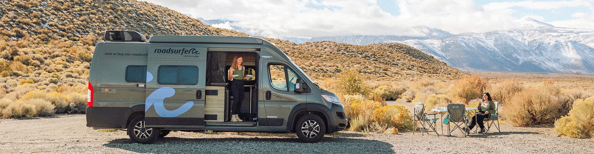Women Camping With A Camper Van And Cooking