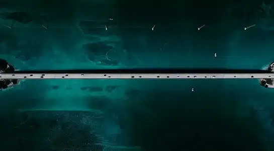 Overhead view of the Seven Mile Bridge stretching across turquoise water in the Florida Keys.