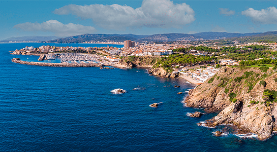 Aerial view of the coast of Palamós and its port in the Costa Brava.