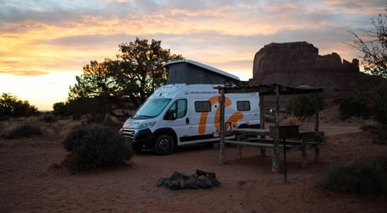 roadsurfer RV parked along a desert highway near Phoenix, surrounded by cacti during an Arizona road trip itinerary