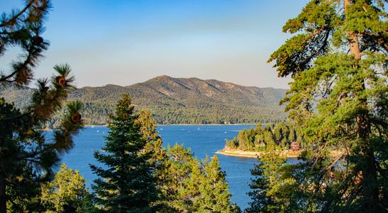 View of Big Bear Lake framed by pine trees, a classic weekend getaway from Los Angeles
