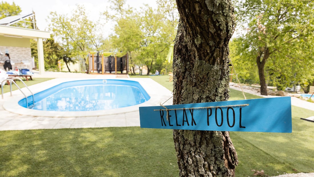 blue relax sign in front of a pool