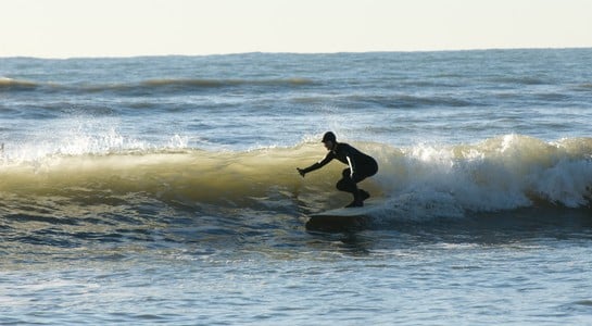 Surfer balancing on a small wave at Bolinas on California’s coast