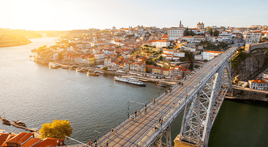 Bird view over bridge leading to the city of porto during sunset