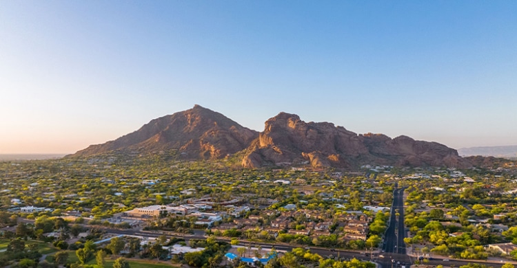 View over the suburbs in Phoenix during sunsets with the Camelback mountain in the background.