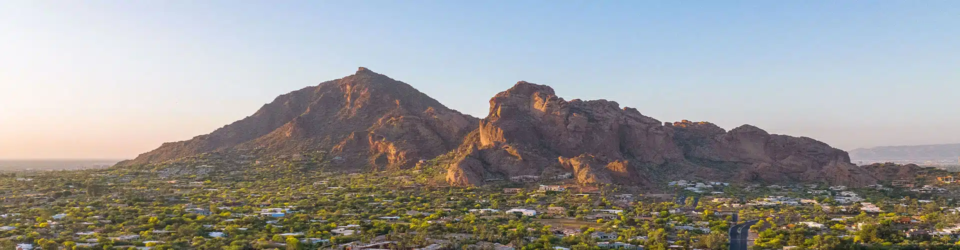 View over the suburbs in Phoenix during sunsets with the Camelback mountain in the background.