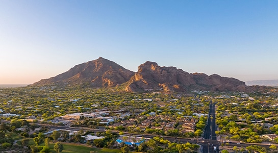 View over the suburbs in Phoenix during sunsets with the Camelback mountain in the background.