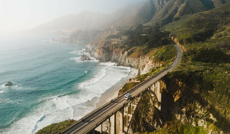 Camper Van Driving Over Bridge