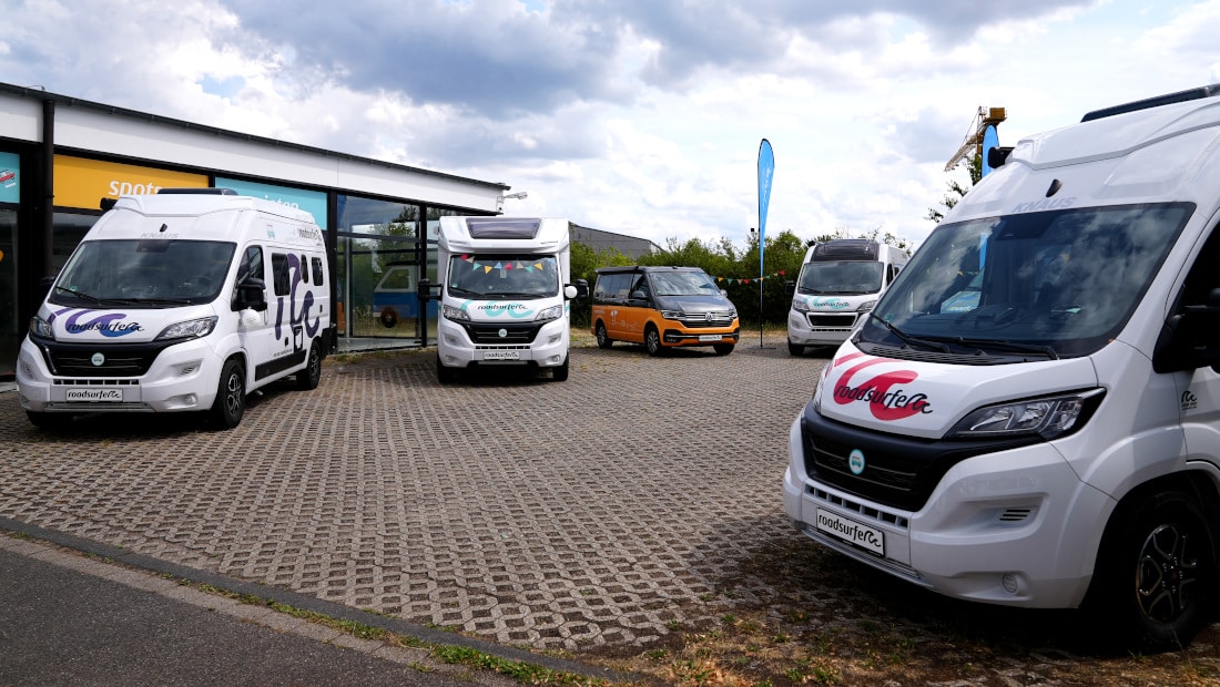 camper vans and motor homes for sale at a roadsurfer station