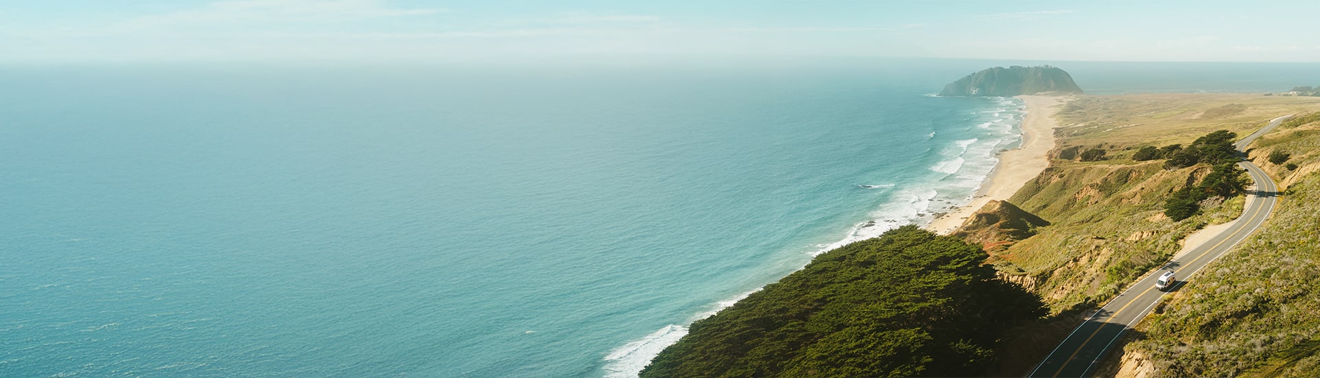 Camper Van Driving Down The Coast Desktop