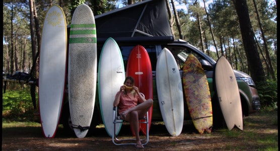 campervan and different sized surfboards