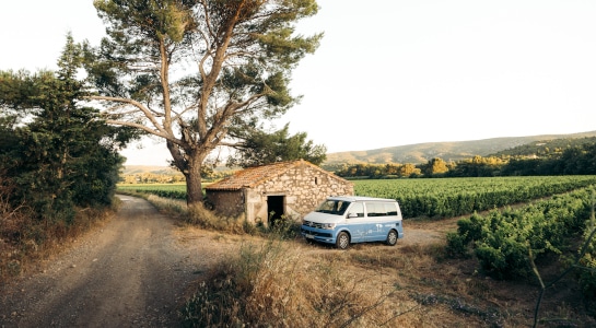 Campervan in front of a stone hat