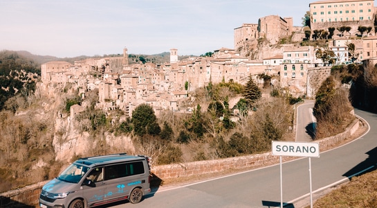 roadsurfer campervan standing on the road in Sorano, Italy