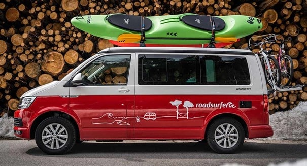 Volkswagen campervan with a kayak on the roof