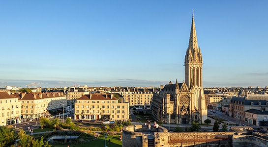 Picture of Cannes showing a church in the centre and buildings built around it.