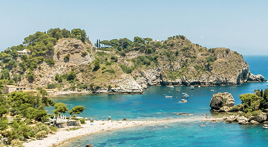 Sky view of some cliffs and a bay at a sicilian beach, in Italy, during a sunny day