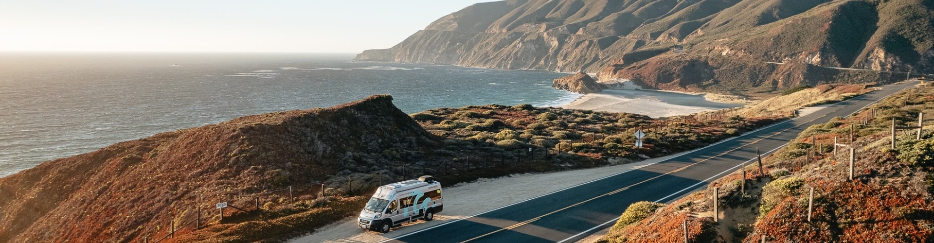 RV parked by the cliffs during sunset near San Francisco, overlooking the Pacific Ocean.