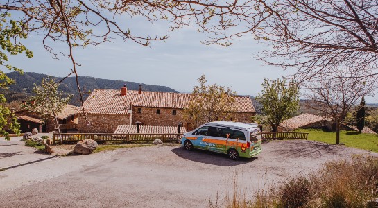colorful mercedes marco polo campervan parked next to a finca