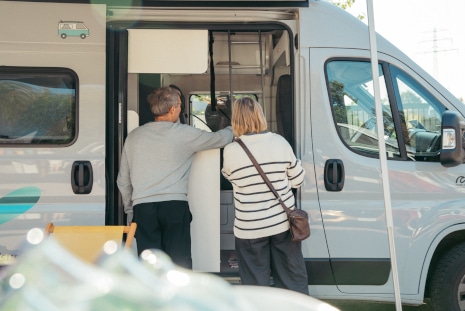 couple-inspecting-interior-of-a-sprinter-type-campervan