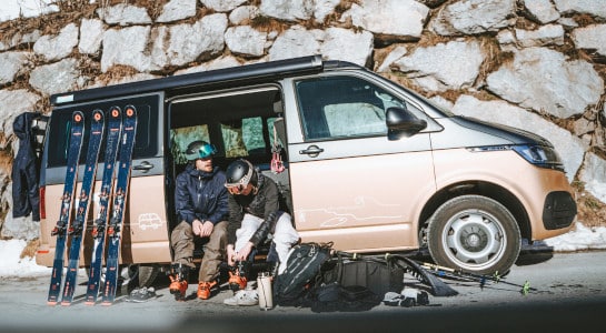couple preparing for skiing in a camper van