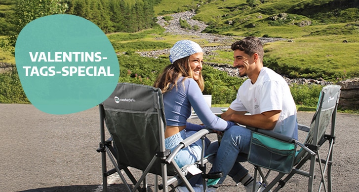 Couple sitting at camping table valentines special