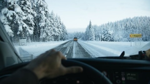 driver view on snowy road during winterizing an RV for cold weather travel