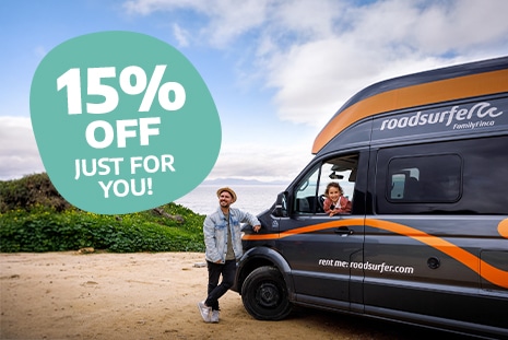 Early Bird Couple with campervan enjoying their roadtrip