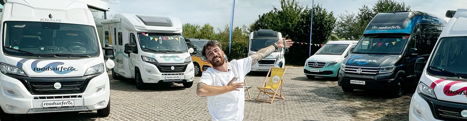 Employee presenting different campervan and motorhome models at a station