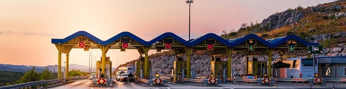 Entrance of a toll road in Europe at sunset