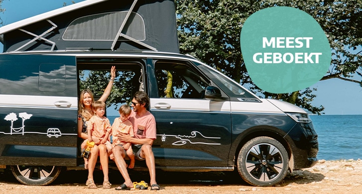 Family sitting in campervn ready for summer holidays