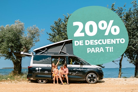 Family of four sitting in the doorway of a campervan