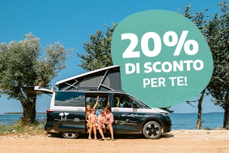 Family of four sitting in the doorway of a campervan