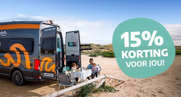 Father with kids sitting on beach in back of a campervan