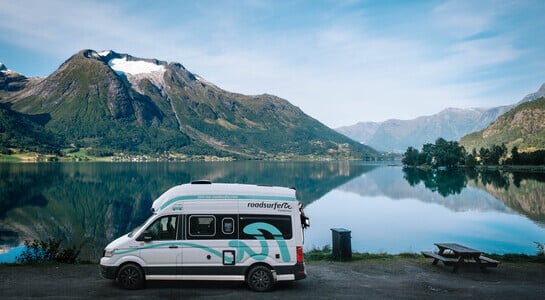 Family motorhome from roadsurfer in front of a lake in Norway