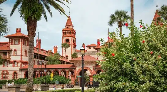 Historic red-brick towers and palm trees at Flagler College in St. Augustine, Florida.