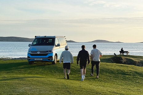 friends-walking-towards-campervan-in-scotland