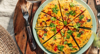 Delicous frittata with potatoes, vegetables and parmesan, view from above