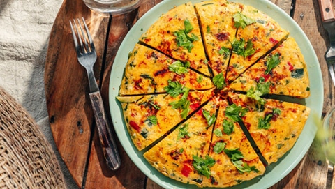 Delicous frittata with potatoes, vegetables and parmesan, view from above