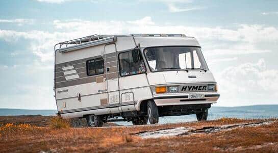 Fully integrated motorhome parked on a hill close to the sea.