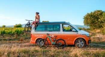 girl-sitting-on-van-with-bike