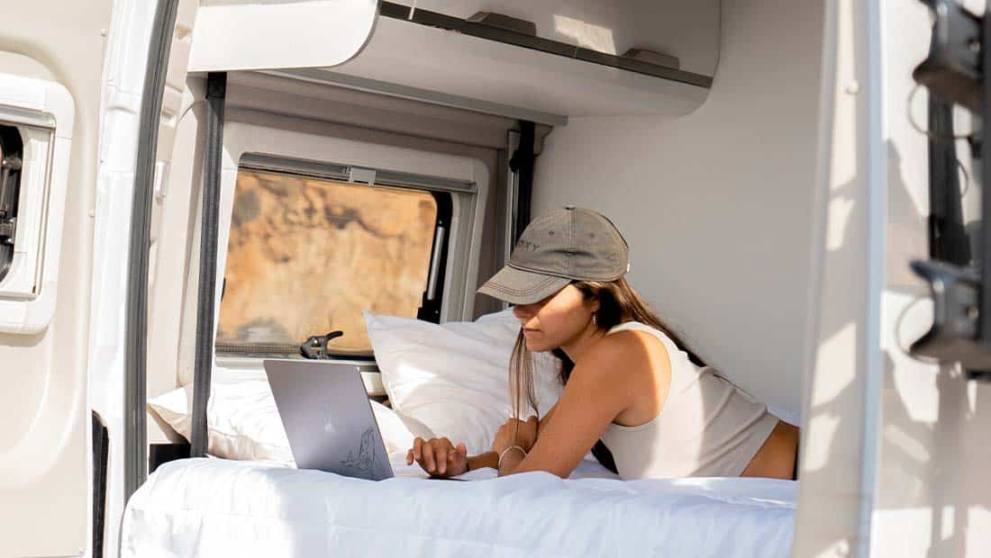 girl with laptop in a campervan
