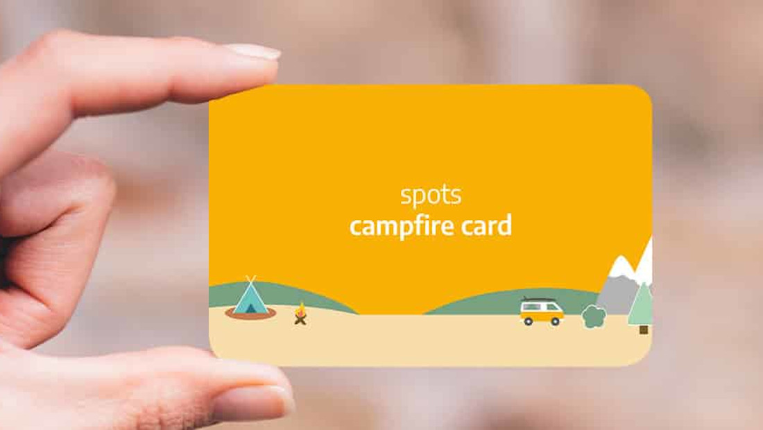 hand holding a yellow roadsurfer spots campfire card