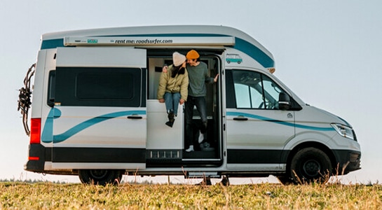 happy couple kissing in the door of a motorhome