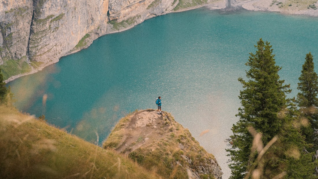 hiker at a blue lake
