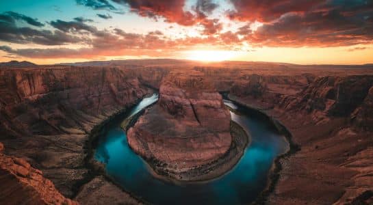 Sunset view over Horseshoe Bend where the Colorado River curves around a sandstone cliff near Page, Arizona