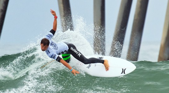 Surfer carving a wave during a Huntington Beach contest heat