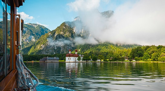 Lake Königssee in Schönau, Germany on a cloudy day and photographed from a small boat.